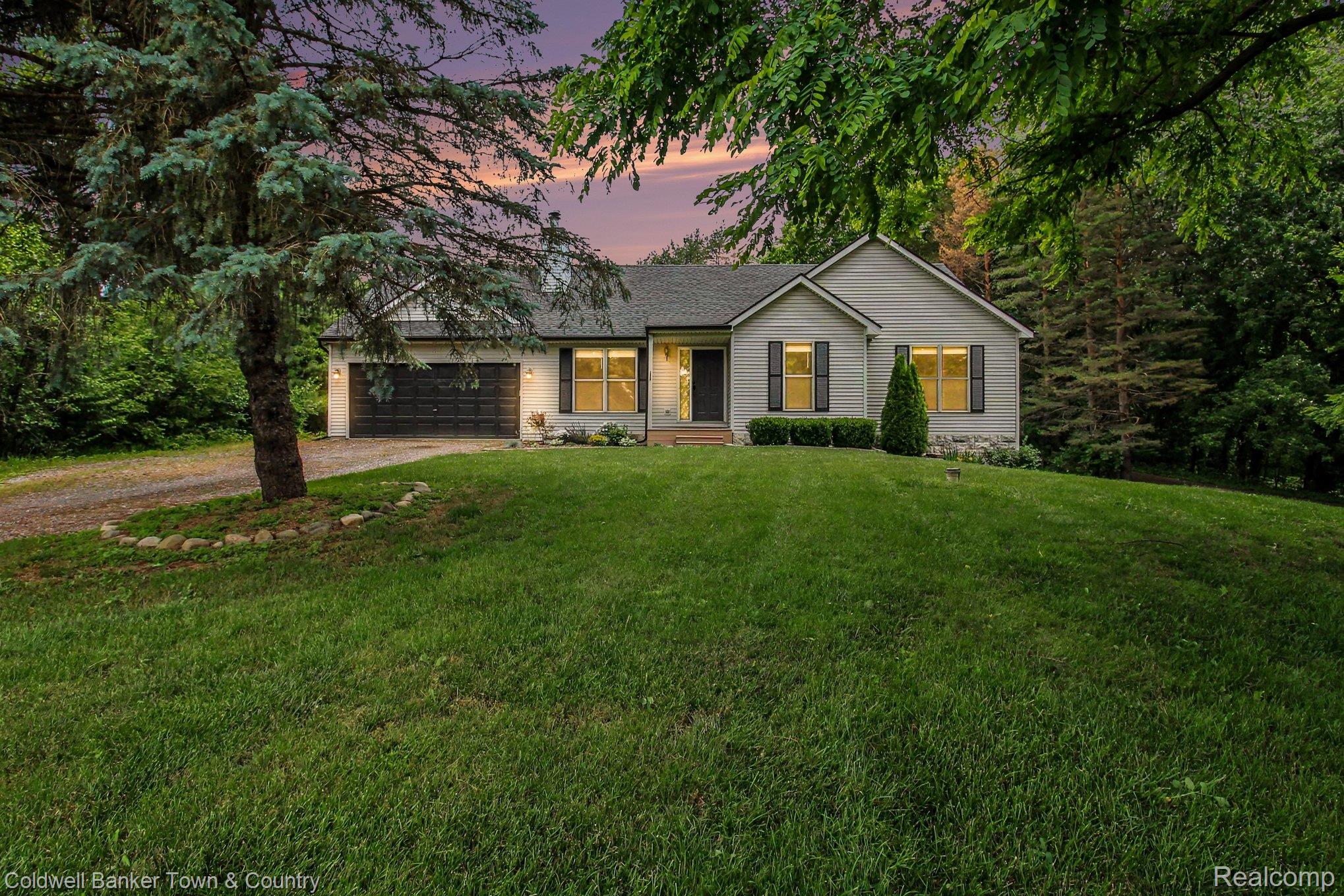332 Triangle Lake Road Howell, MI 48843 - Photo 2 of 27 Light-colored siding exterior with dark shutters and stone accents