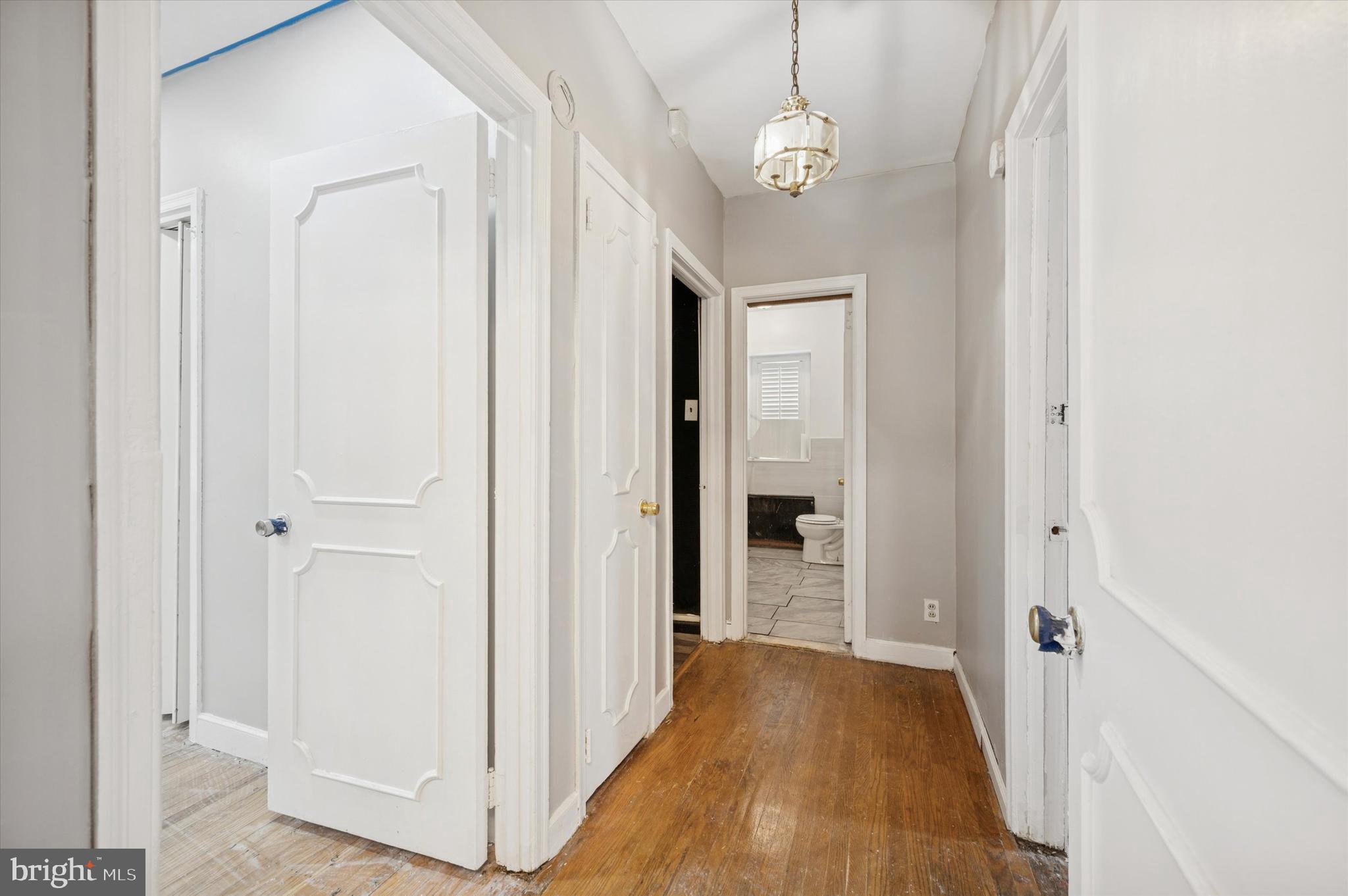 7500 Manchester Road Elkins Park, PA 19027 - Photo 11 of 23 a view of a hallway with wooden floor and chandelier