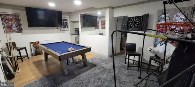 a view of a room with furniture and flat screen tv