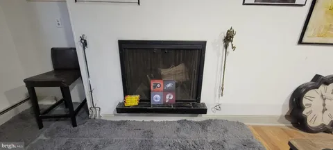 a view of fireplace with wooden floor