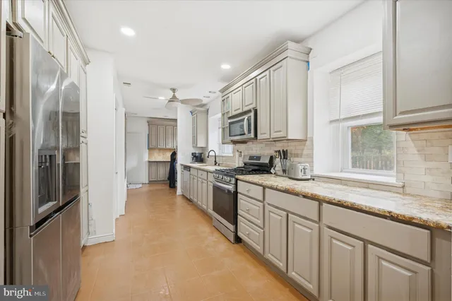 a large kitchen with cabinets and stainless steel appliances
