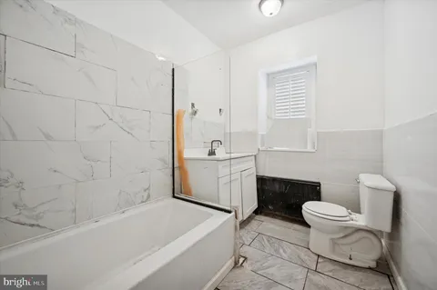 a bathroom with a sink a toilet and a bathtub