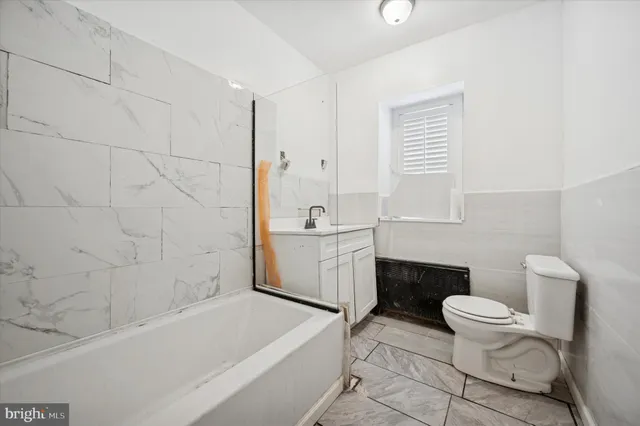 a bathroom with a sink a toilet and a bathtub