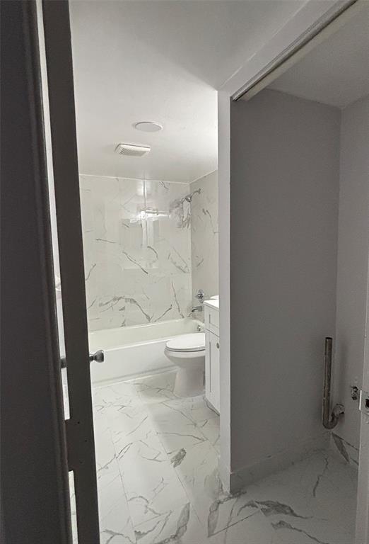 4152 Inverrary Drive, Unit 101 Lauderhill, FL 33319 - Photo 10 of 11 a bathroom with a granite countertop shower and a toilet