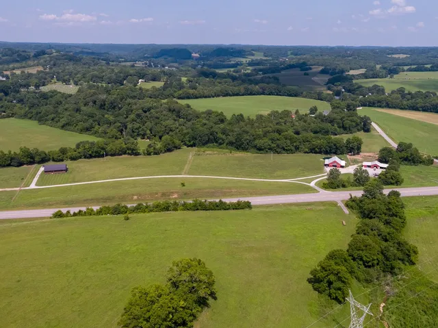 an aerial view of a houses with a lake