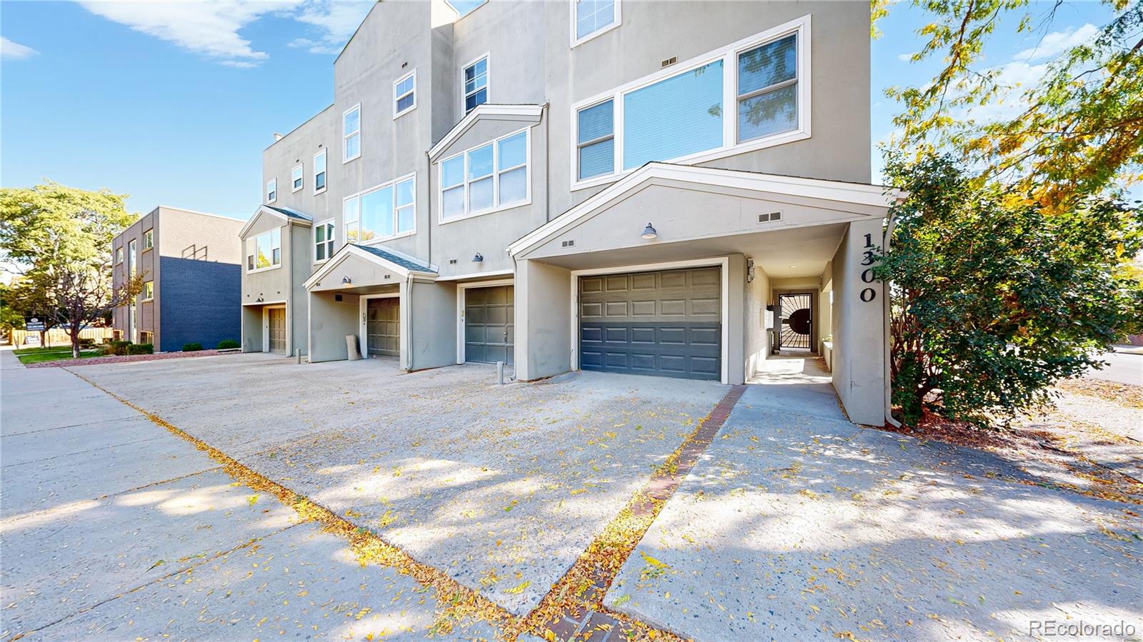 1300 Garfield Street, Unit 1A Denver, CO 80206 - Photo 1 of 33 a front view of a house with a yard and garage