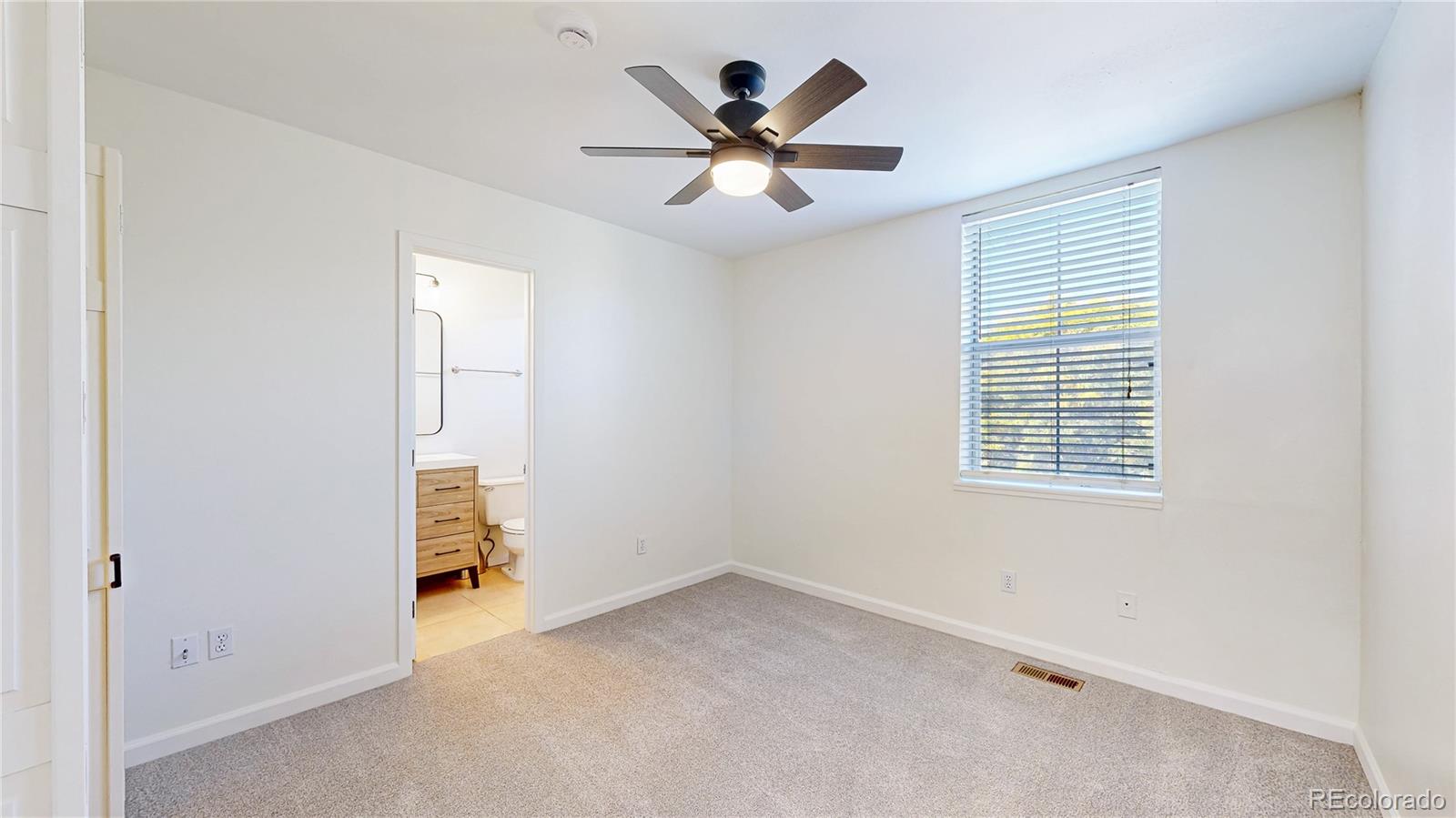 1300 Garfield Street, Unit 1A Denver, CO 80206 - Photo 11 of 33 an empty room with a ceiling fan and window