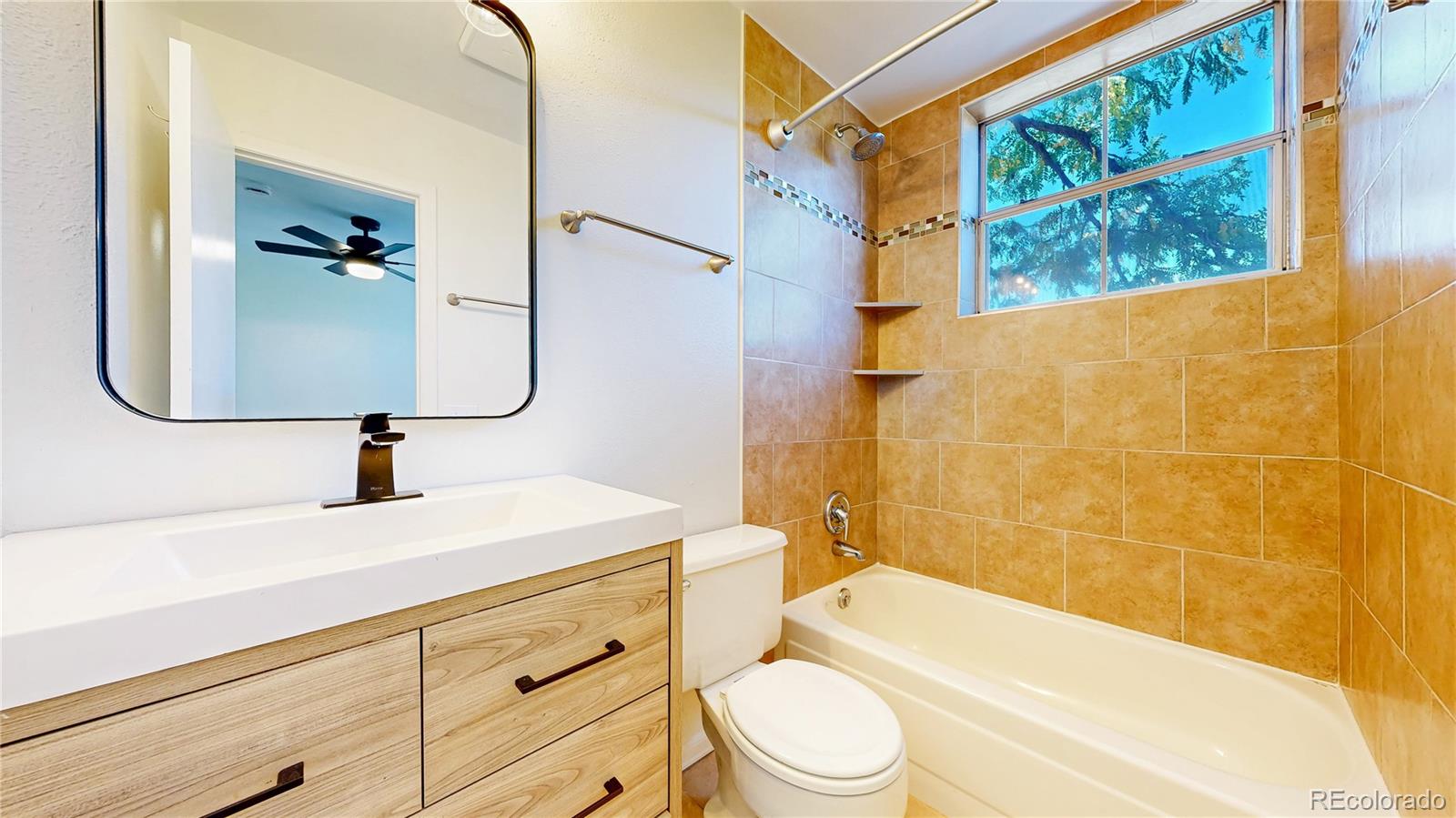 1300 Garfield Street, Unit 1A Denver, CO 80206 - Photo 14 of 33 a bathroom with a sink a toilet and bathtub