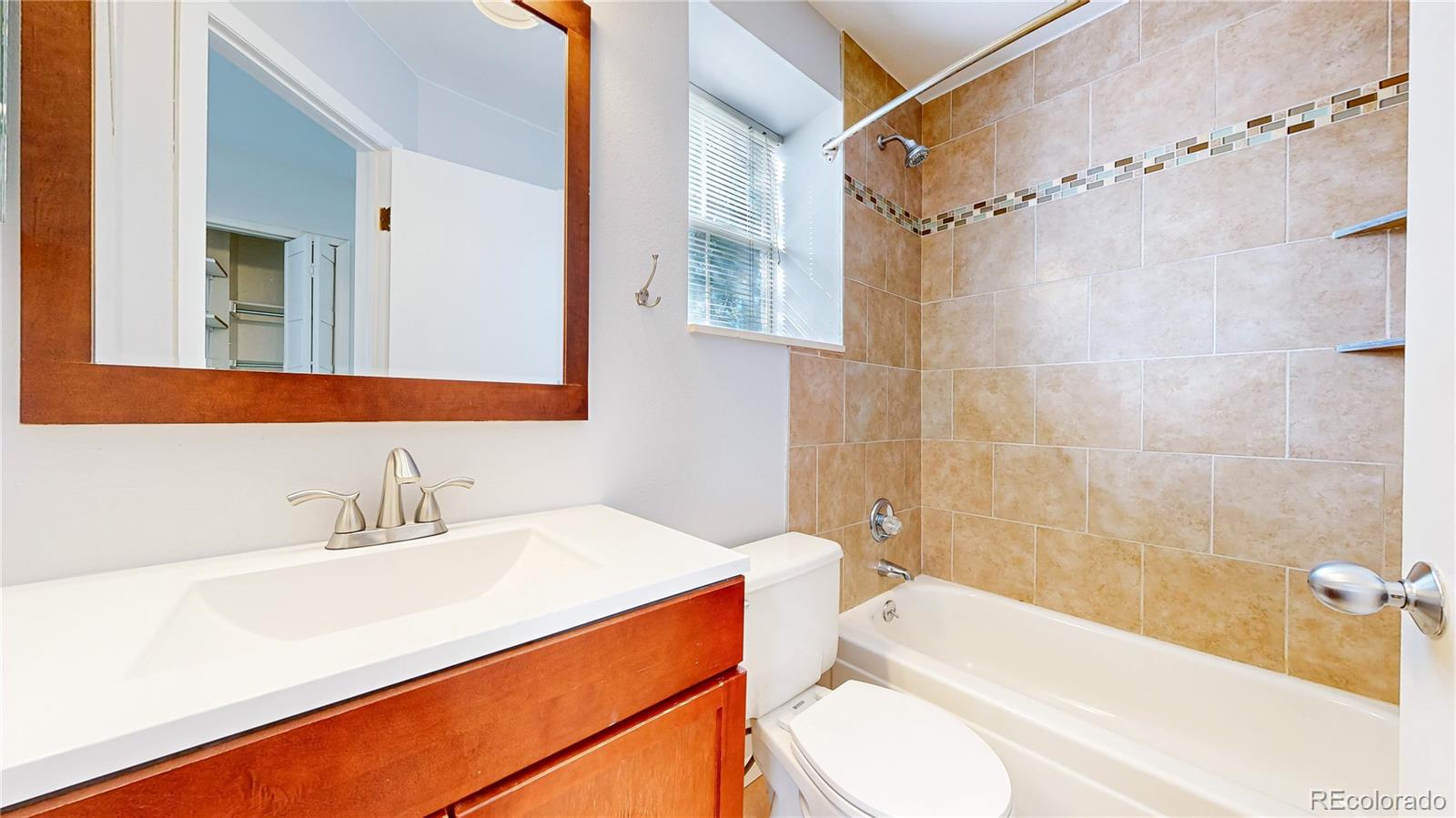 1300 Garfield Street, Unit 1A Denver, CO 80206 - Photo 18 of 33 a bathroom with a sink a toilet and a bathtub