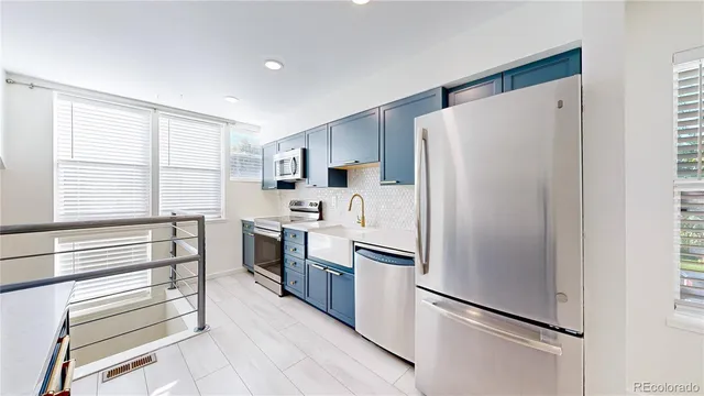 a kitchen with a refrigerator and a sink