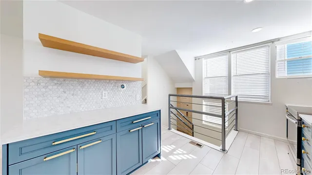 a kitchen with white cabinets and a wooden floor