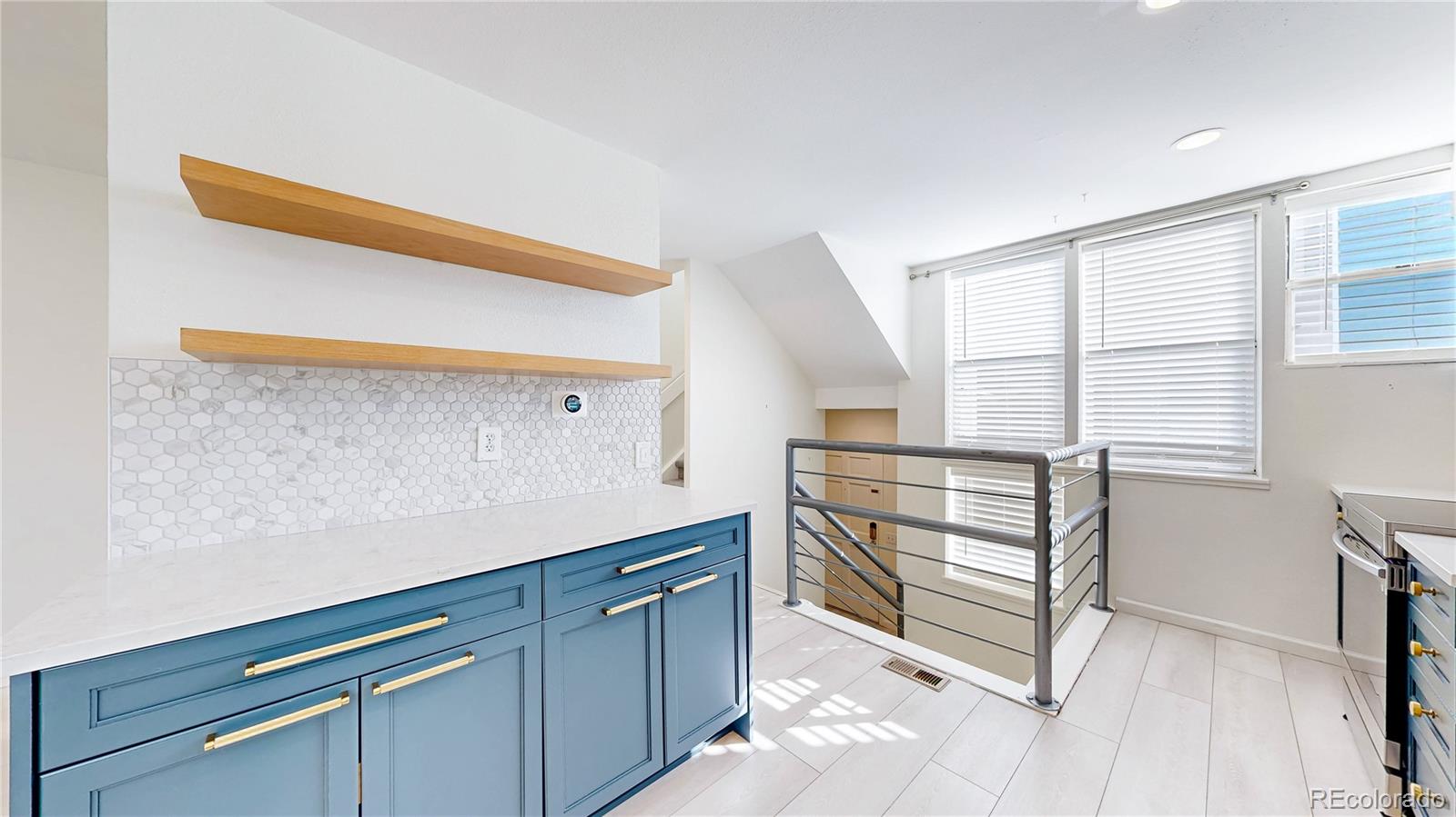 1300 Garfield Street, Unit 1A Denver, CO 80206 - Photo 5 of 33 a kitchen with white cabinets and a wooden floor