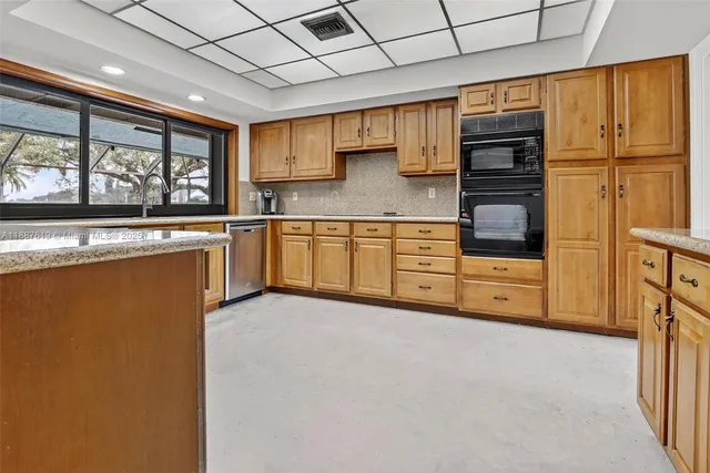 a kitchen with stainless steel appliances granite countertop a refrigerator and cabinets