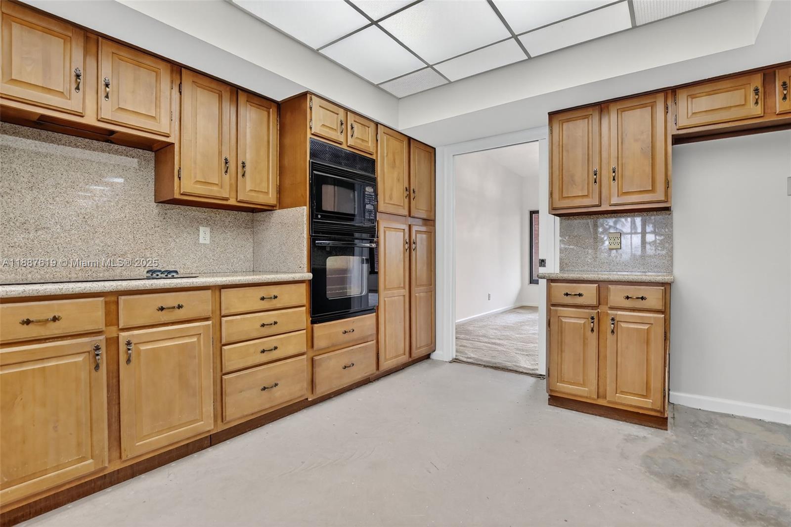 100 129th Avenue Plantation, FL 33325 - Photo 23 of 60 a kitchen with stainless steel appliances granite countertop a refrigerator and cabinets