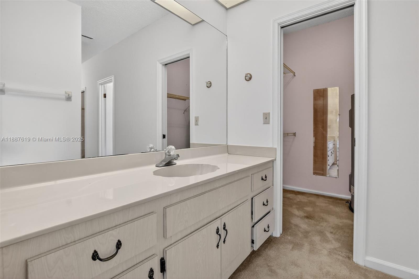 100 129th Avenue Plantation, FL 33325 - Photo 28 of 60 a bathroom with a sink and a mirror