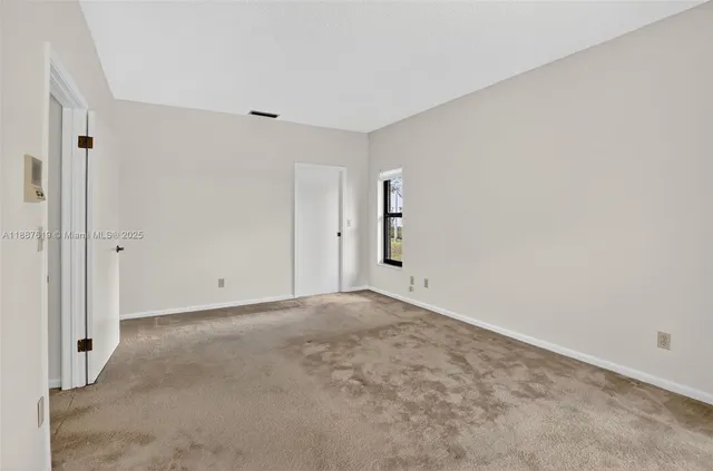 a view of a livingroom with storage and utility room