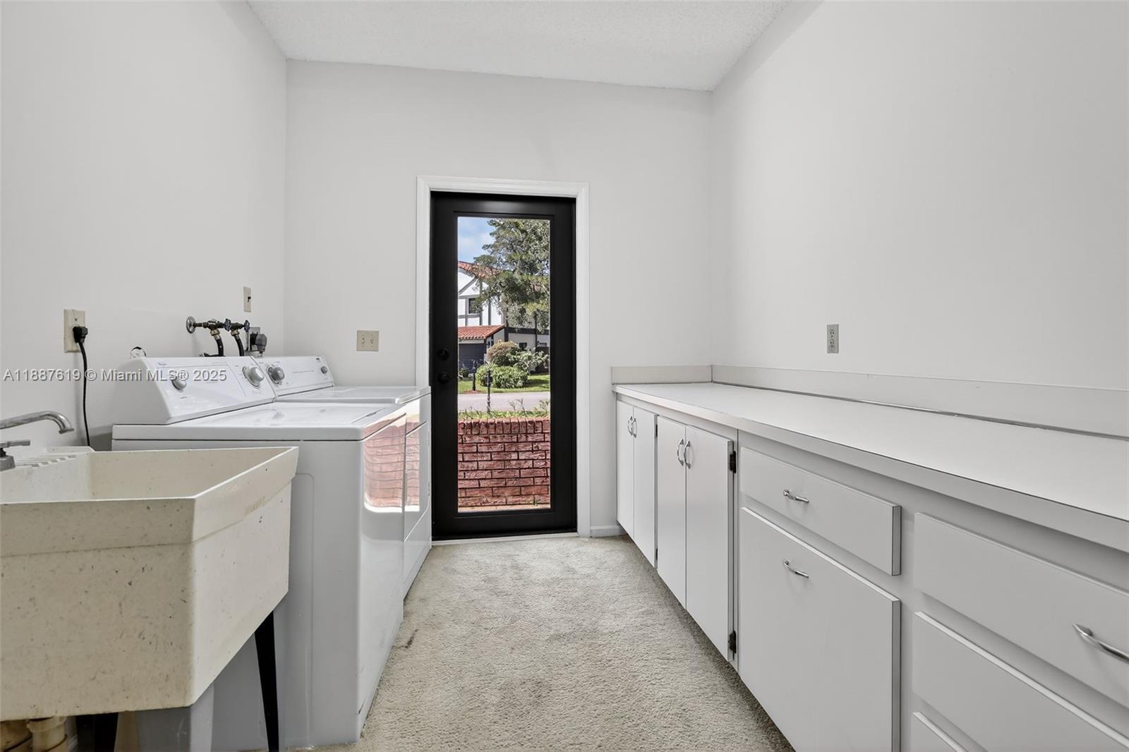 100 129th Avenue Plantation, FL 33325 - Photo 42 of 60 a utility room with cabinets washer and dryer