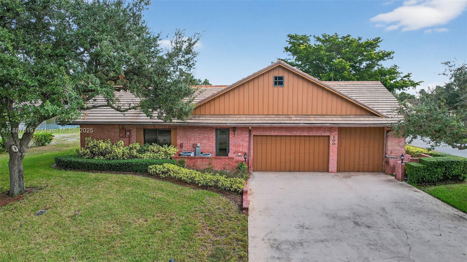 100 129th Avenue Plantation, FL 33325 - Photo 58 of 60 a front view of a house with a yard and garage