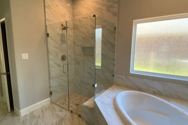 a bathroom with a tub and shower
