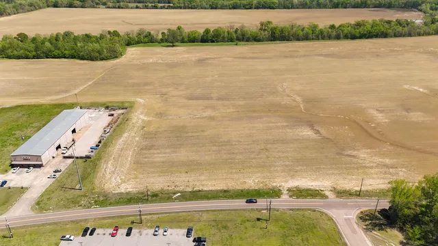 an aerial view of a house with swimming pool and outdoor seating