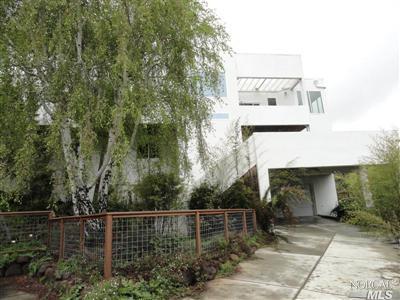 a view of a patio with table and chairs and potted plants with wooden floor