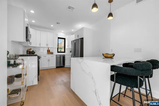 a kitchen with a sink cabinets and window