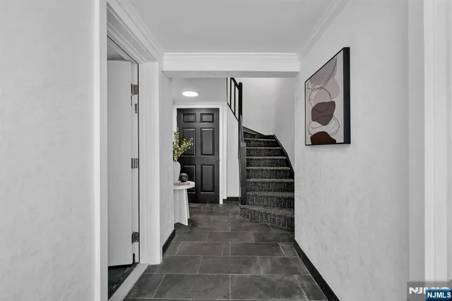 a view of a hallway with wooden floor and entryway