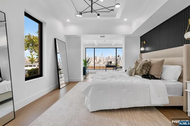 a large bedroom with a bed and a large window