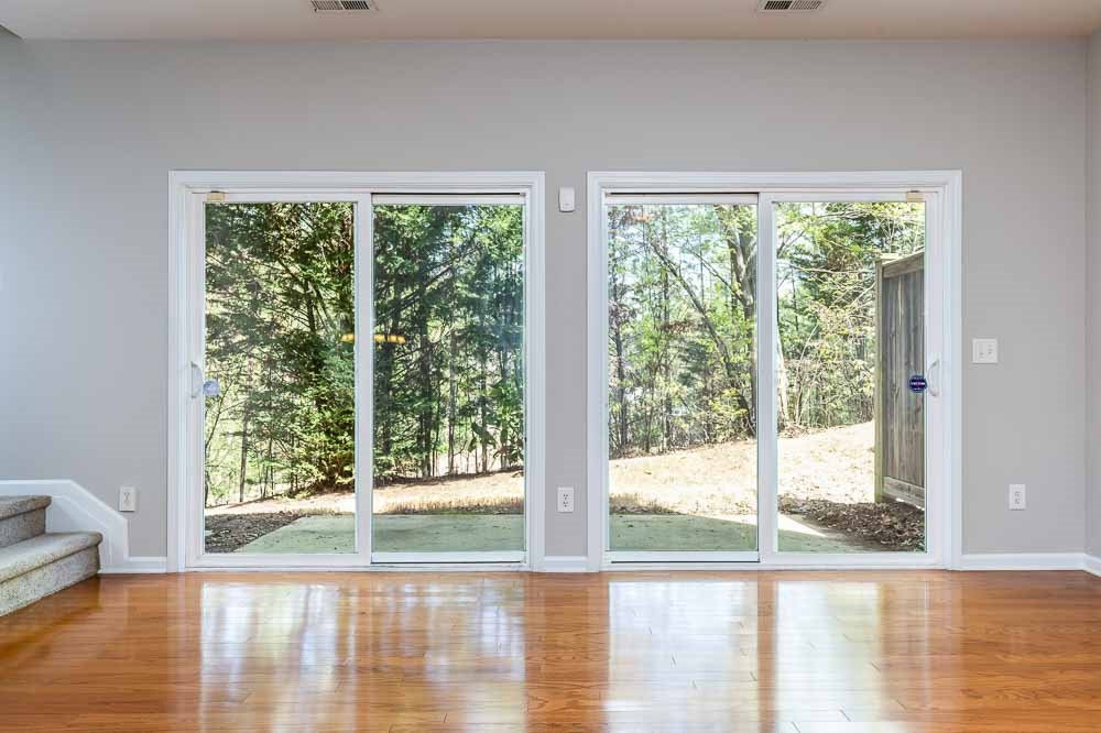 8722 Owl Roost Place Raleigh, NC 27617 - Photo 9 of 26 Double sliders welcome in the wooded back yard with abundant privacy! Living Room
