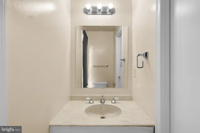 a bathroom with a sink a mirror and a vanity
