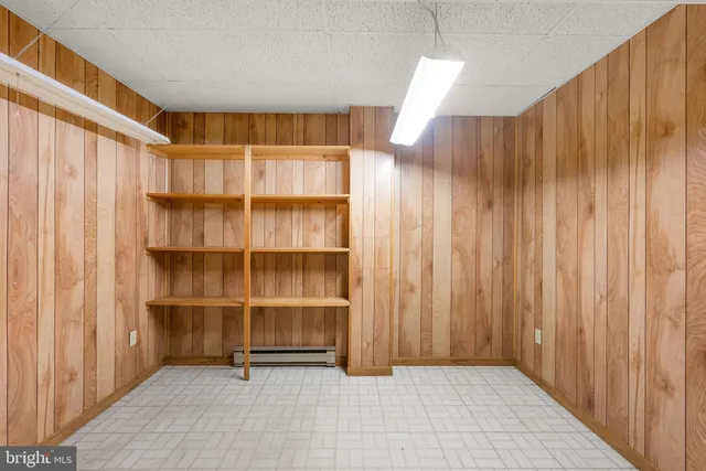 a view of an empty room with a window and stairs