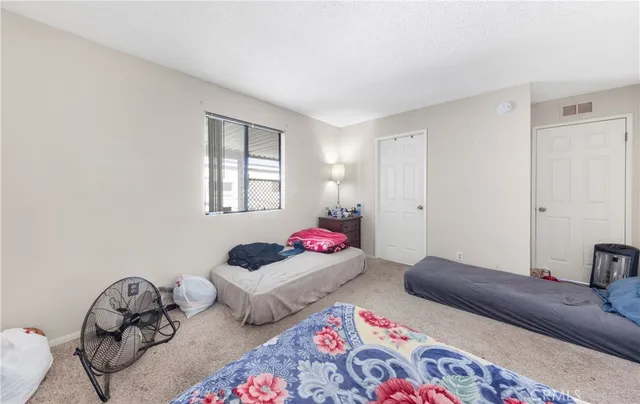 a bedroom with two beds and a couch