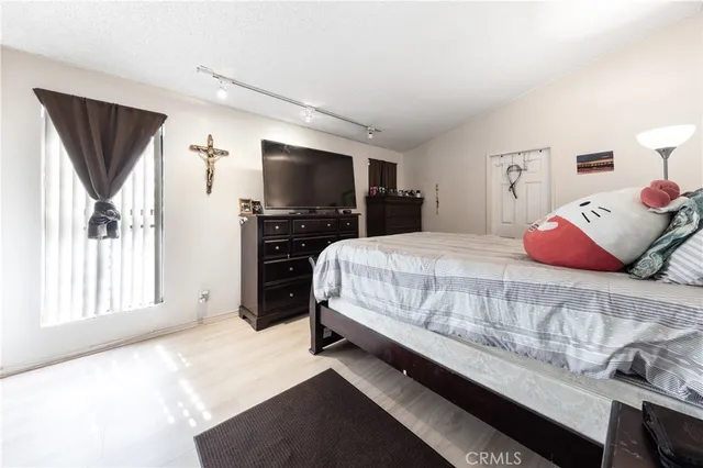 a bedroom with a bed and flat screen tv