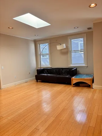 a living room with hard wood floors and a wooden floors