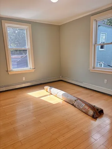 a view of a room with wooden floor and cabinet