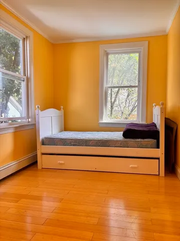 a view of a balcony with wooden floor and fence