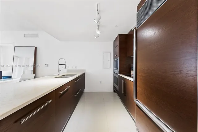 a large room with a lot of cabinets and wooden floor