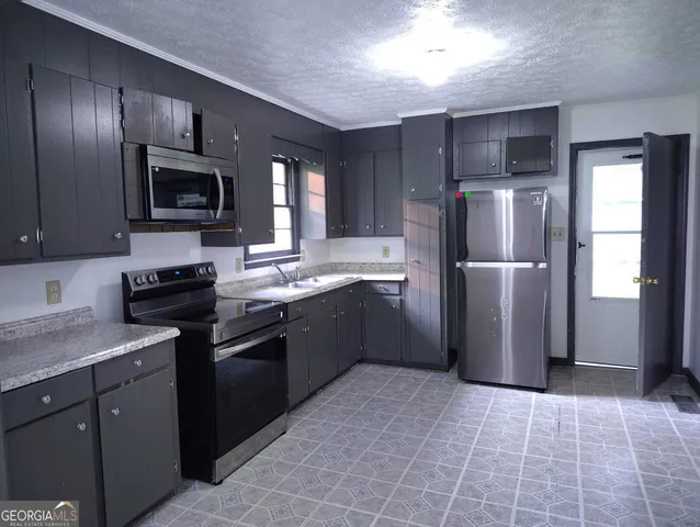 a kitchen with a refrigerator sink and microwave