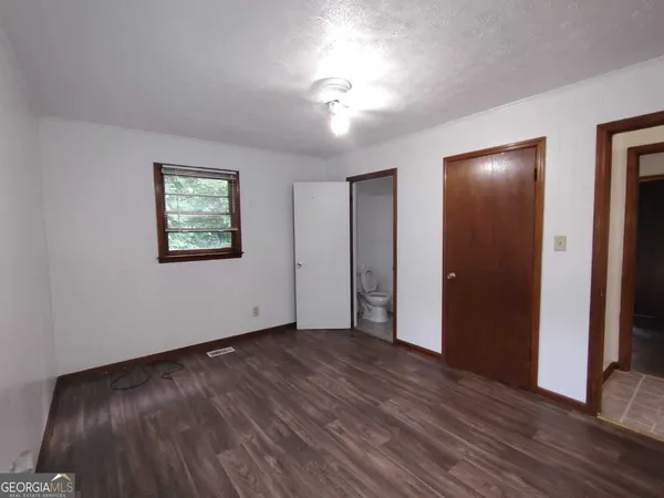 a bathroom with a granite countertop toilet and a shower