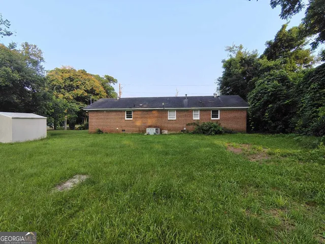 a front view of house with a garden