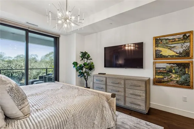 a bedroom with a bed and a television