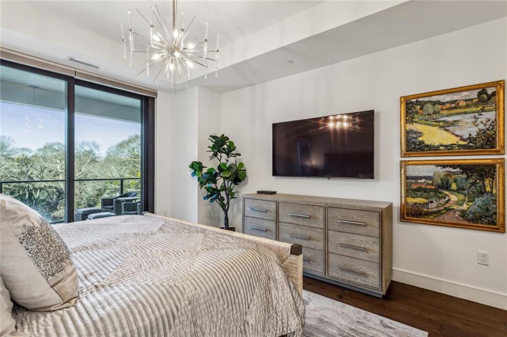 2520 Peachtree Road, Unit 602 Atlanta, GA 30305 - Photo 13 of 45 a bedroom with a bed and a flat screen tv