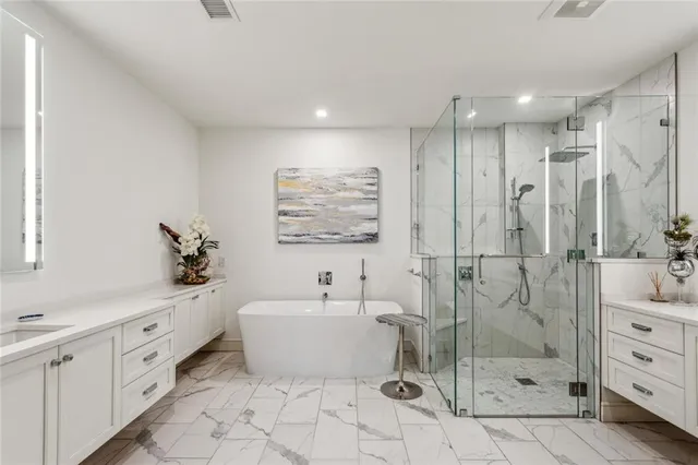 a bathroom with a double vanity sink mirror and shower