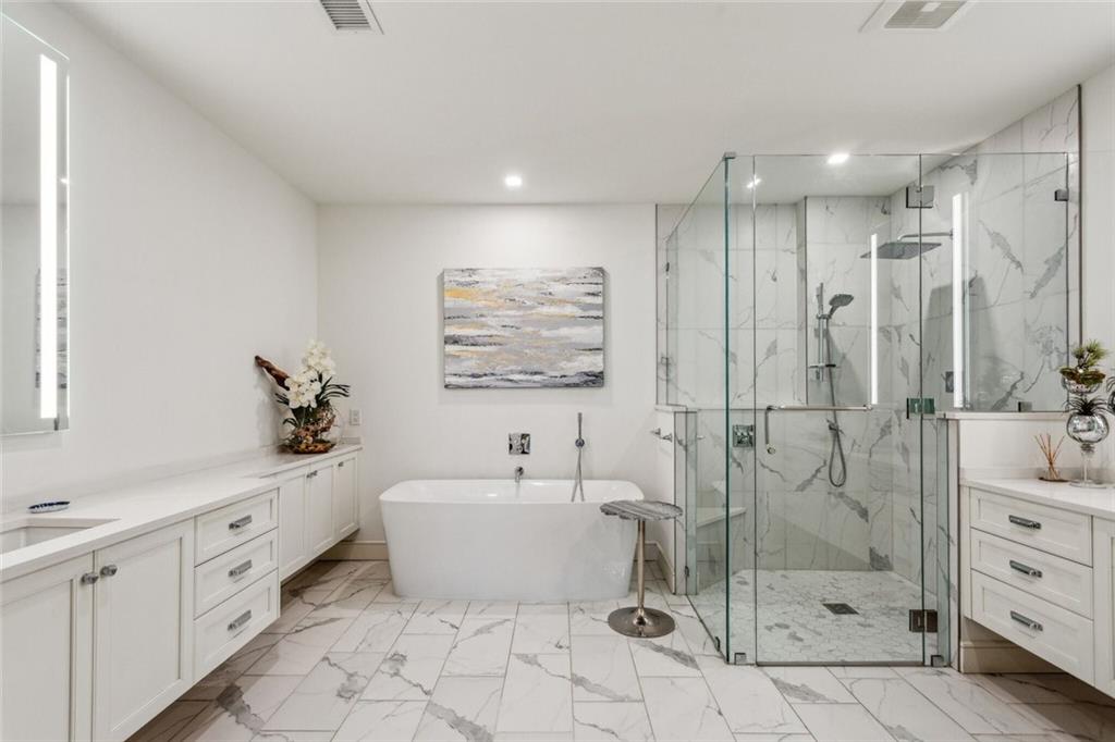 2520 Peachtree Road, Unit 602 Atlanta, GA 30305 - Photo 16 of 45 a spacious bathroom with a shower sink and mirror