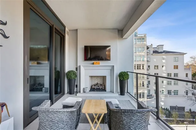 a view of a balcony with chairs and wooden floor