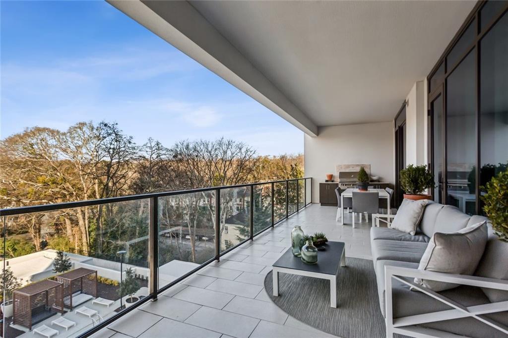 2520 Peachtree Road, Unit 602 Atlanta, GA 30305 - Photo 29 of 45 a view of a balcony with chairs and potted plants