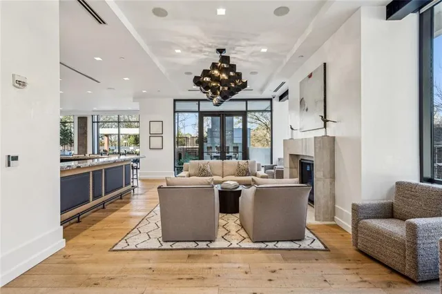 a living room with furniture and large windows