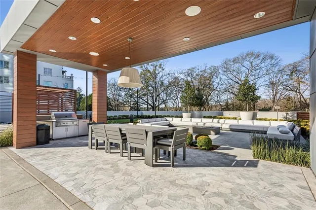 a view of outdoor sitting area with furniture and fire pit