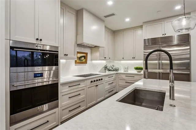 a large kitchen with a table and chairs