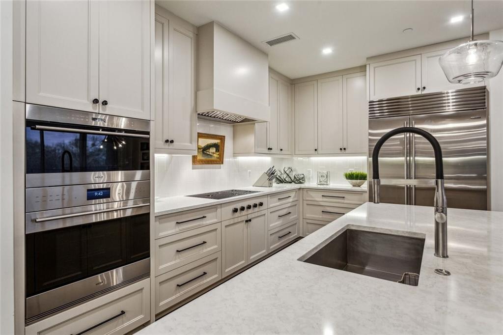 2520 Peachtree Road, Unit 602 Atlanta, GA 30305 - Photo 8 of 45 a kitchen with stainless steel appliances granite countertop a stove a sink and a microwave